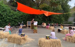 students spaced out on straw bales