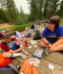 Ian, (NIT) playing cards with campers
