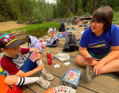 Ian, (NIT) playing cards with campers