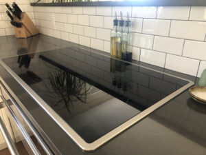 a black induction stove on a grey countertop