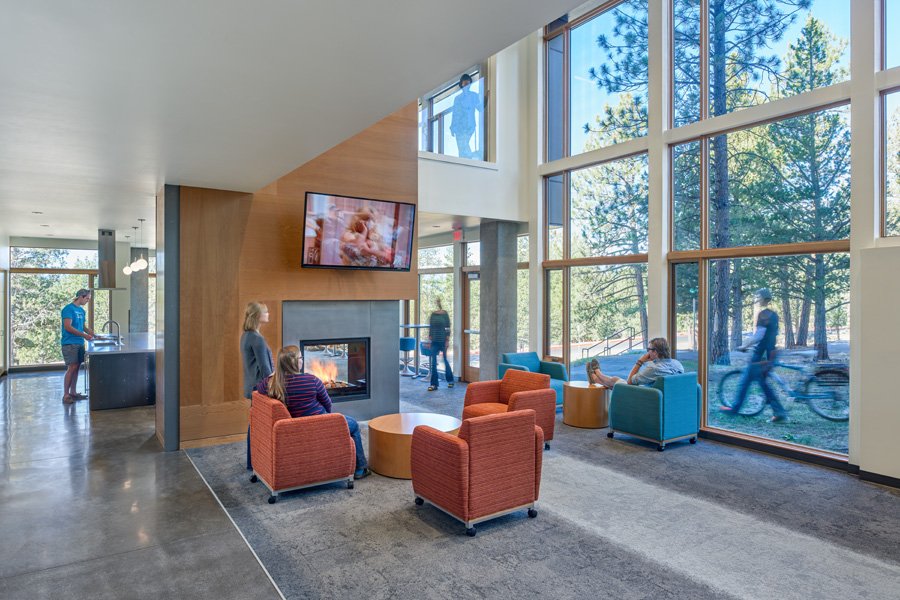Interior of residence hall with couches and glass exterior