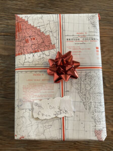 Handwrapped gift from old map and reused ribbon