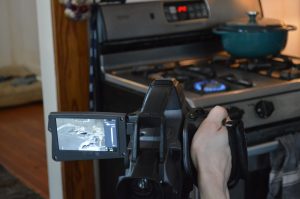 a handheld camera films a gas stove. one can see a grey blur in the camera's viewfinder, picking up invisible gas fumes
