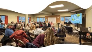 A room full of seated attendees with a presentation slide that reads Sorting Truth from Trash