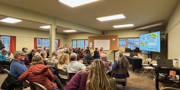 A pic of seated attendees in a room with presentation slide reading Sorting Truth from Trash