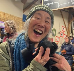 A woman looking very happy showing off a strap