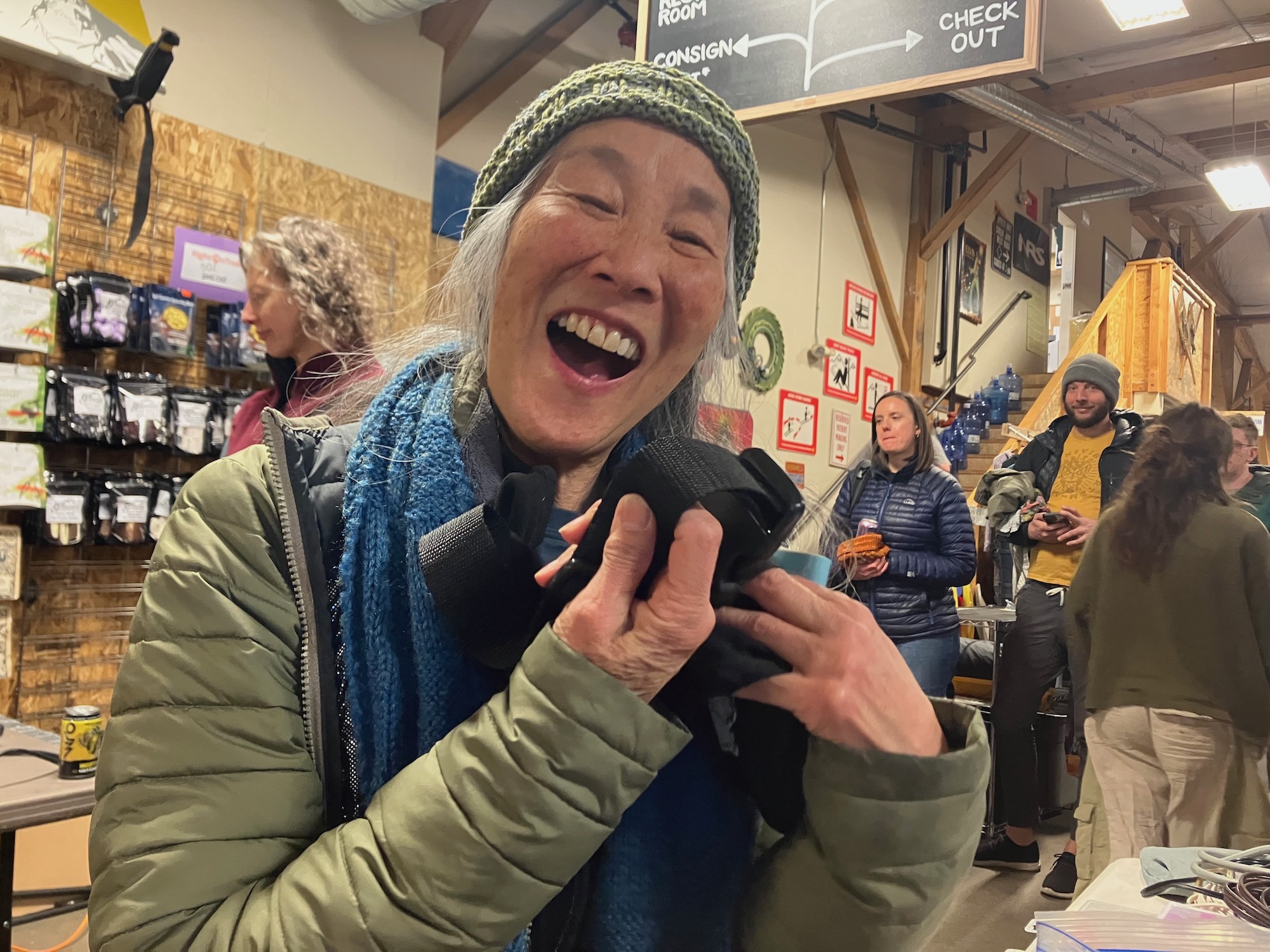 A woman looking very happy showing off a strap