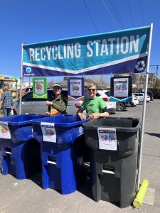 Recycling or sorting station with two volunteers in a parking lot
