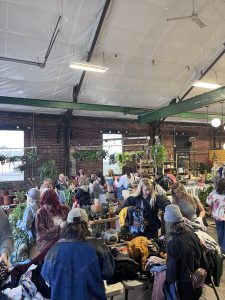 People at an indoor clothing swap