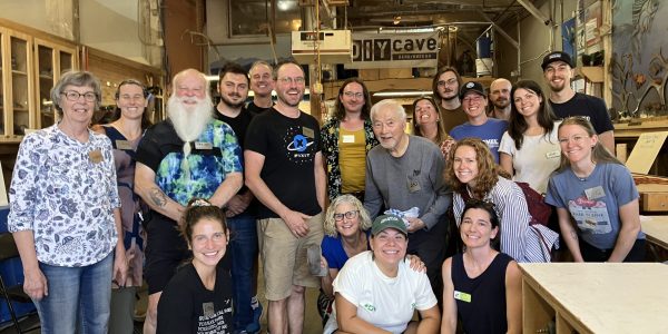 group of 20 staff and volunteers smiling