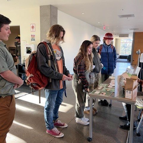 COCC students visit Jessie Spendlove at the educational green hygiene table with information about the
toothpaste, laundry detergent, washing on cold saves energy, information on Saalt and All Matters companies