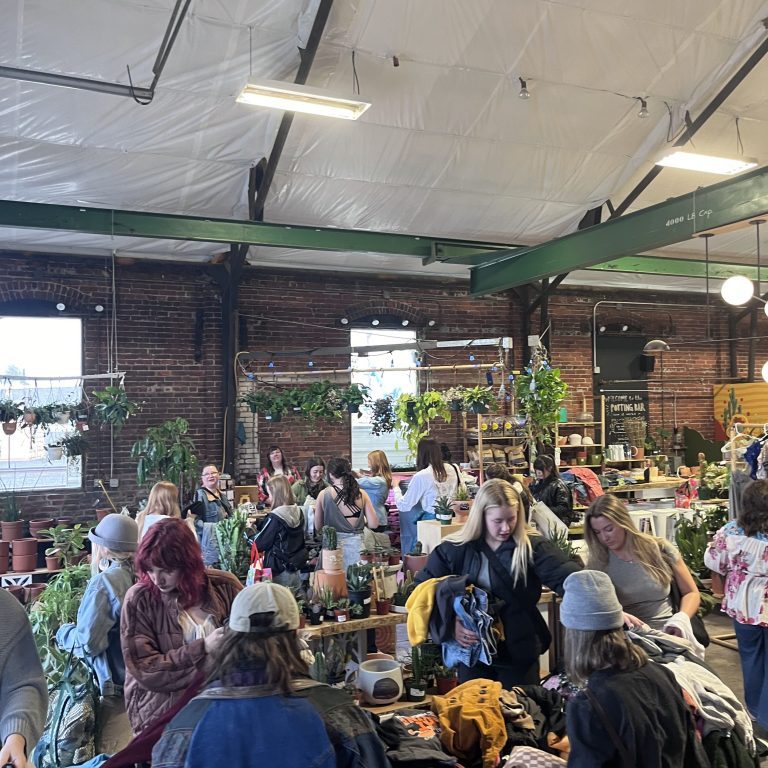 People at an indoor clothing swap