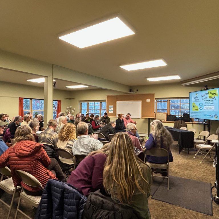 A pic of seated attendees in a room with presentation slide reading Sorting Truth from Trash